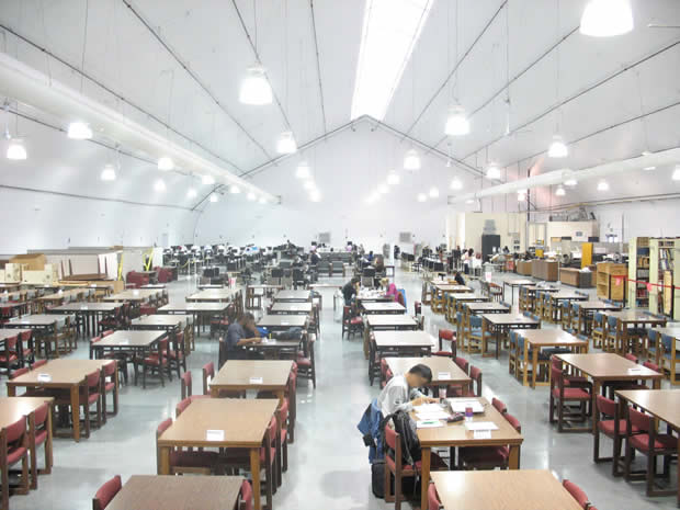 Study room with tables, chairs, and students