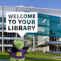 Library building with a toy gator saying "Welcome to your library"
