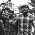 A group of mostly Black students chanting with raised fists and protest signs during the SF State Strike