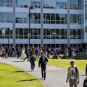 People walk across the quad in front of the J. Paul Leonard Library