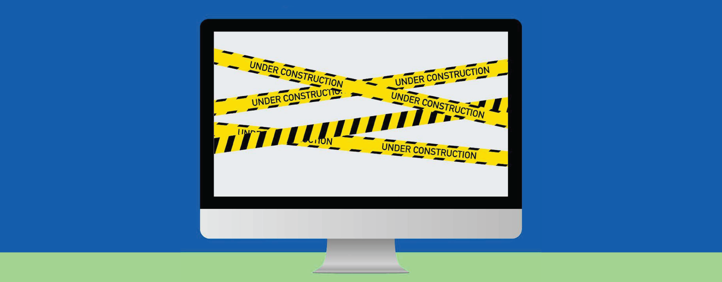 Computer wrapped in yellow-and-black "Under Construction" tape