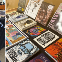 Books with afrofuturist themes and artwork on a starry tablecloth