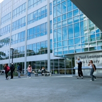 People entering the SFSU Library's main entrance