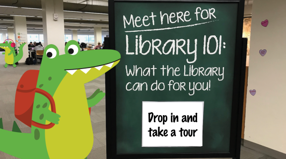 Cartoon gator in the Library next to a sign reading: "Drop in and take a tour"