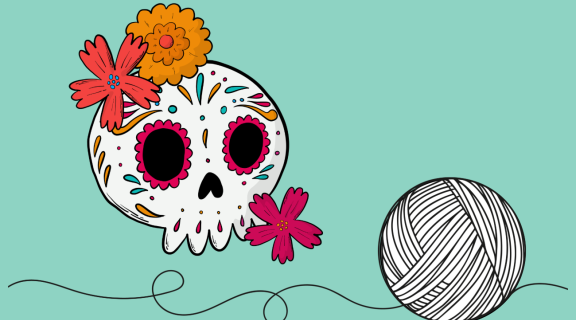 Ball of yarn and cartoon skull with flowers and painted decorations