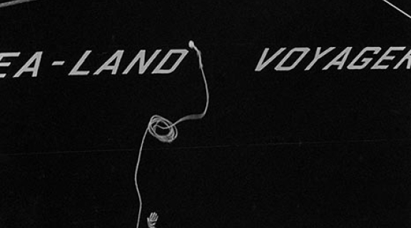 Worker throwing a rope to a ship