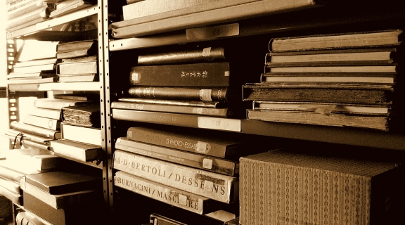 Old/rare books stacked on shelves