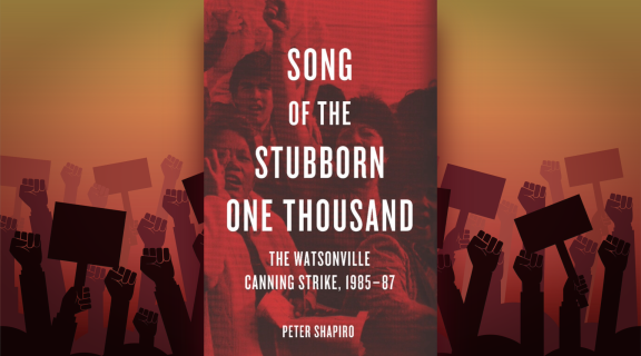 Red book cover against a background of protesters