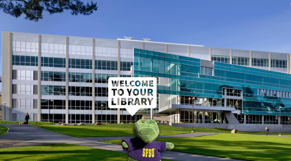 A small toy gator in an SFSU T-shirt says "Welcome to your Library"